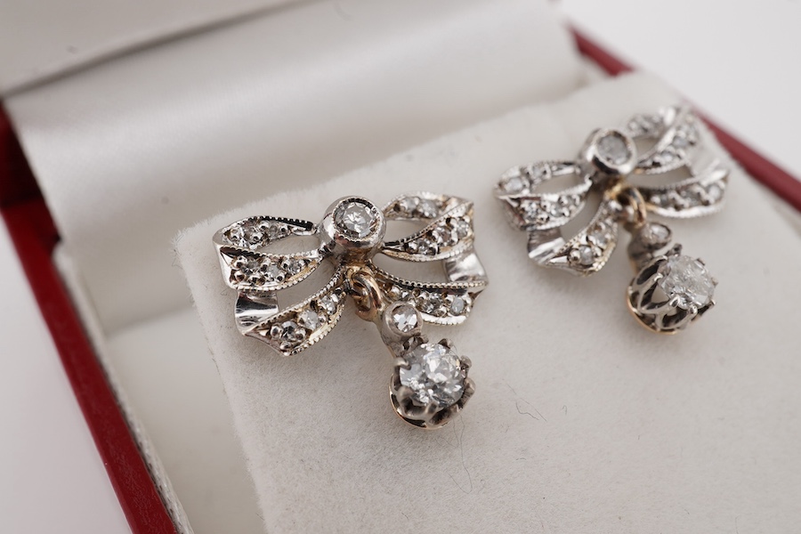 A pair of 9k and diamond cluster set ribbon bow drop earrings, overall drop 12mm, gross weight 2.2 grams. Condition - fair to good